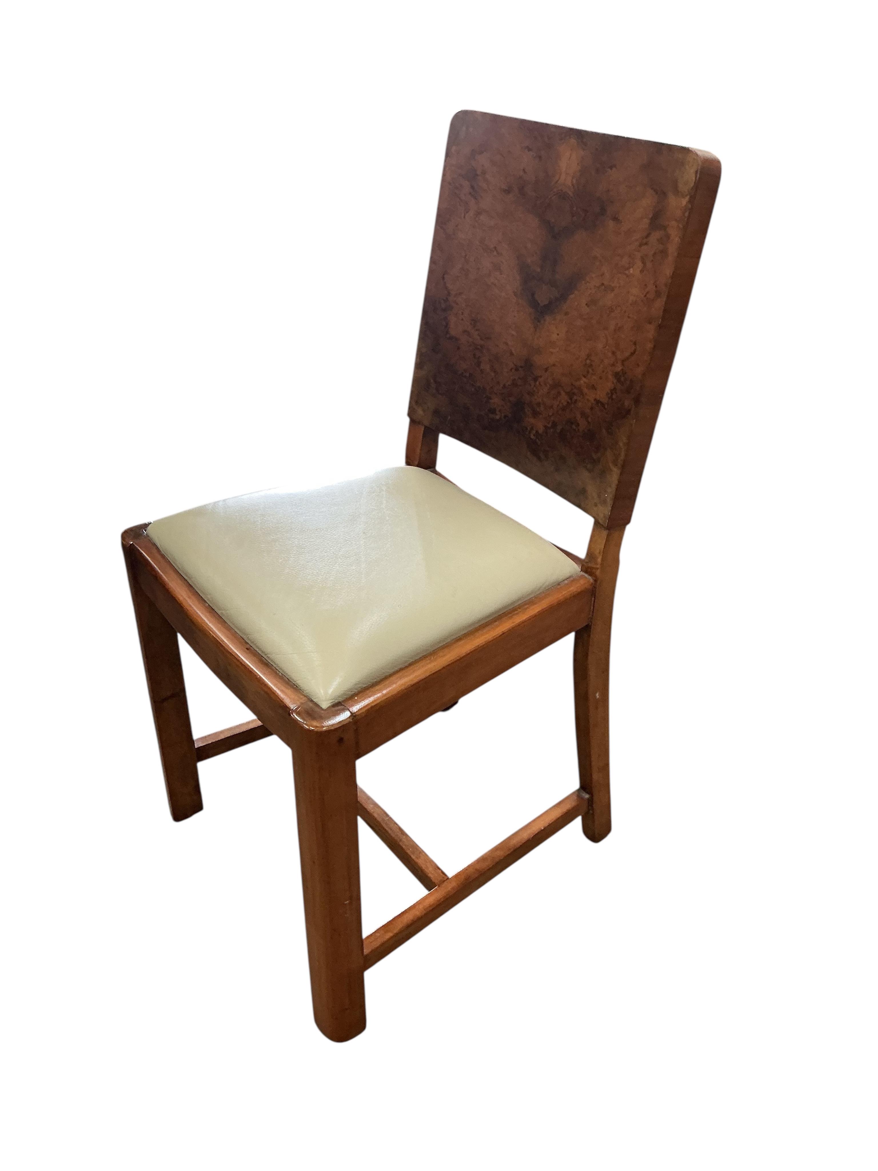 An Art Deco style rectangular walnut dining table, width 180cm, depth 94cm, height 75cm and six chairs